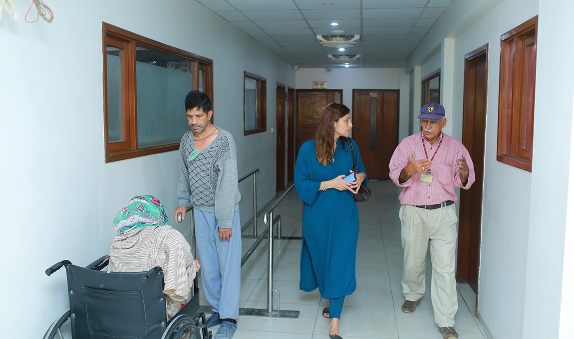 Mrs. Ayesha Shaikh is getting a briefing about the Rabia Moon Trust by a senior representative